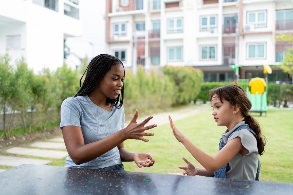 A caregiver playing outdoors with a child